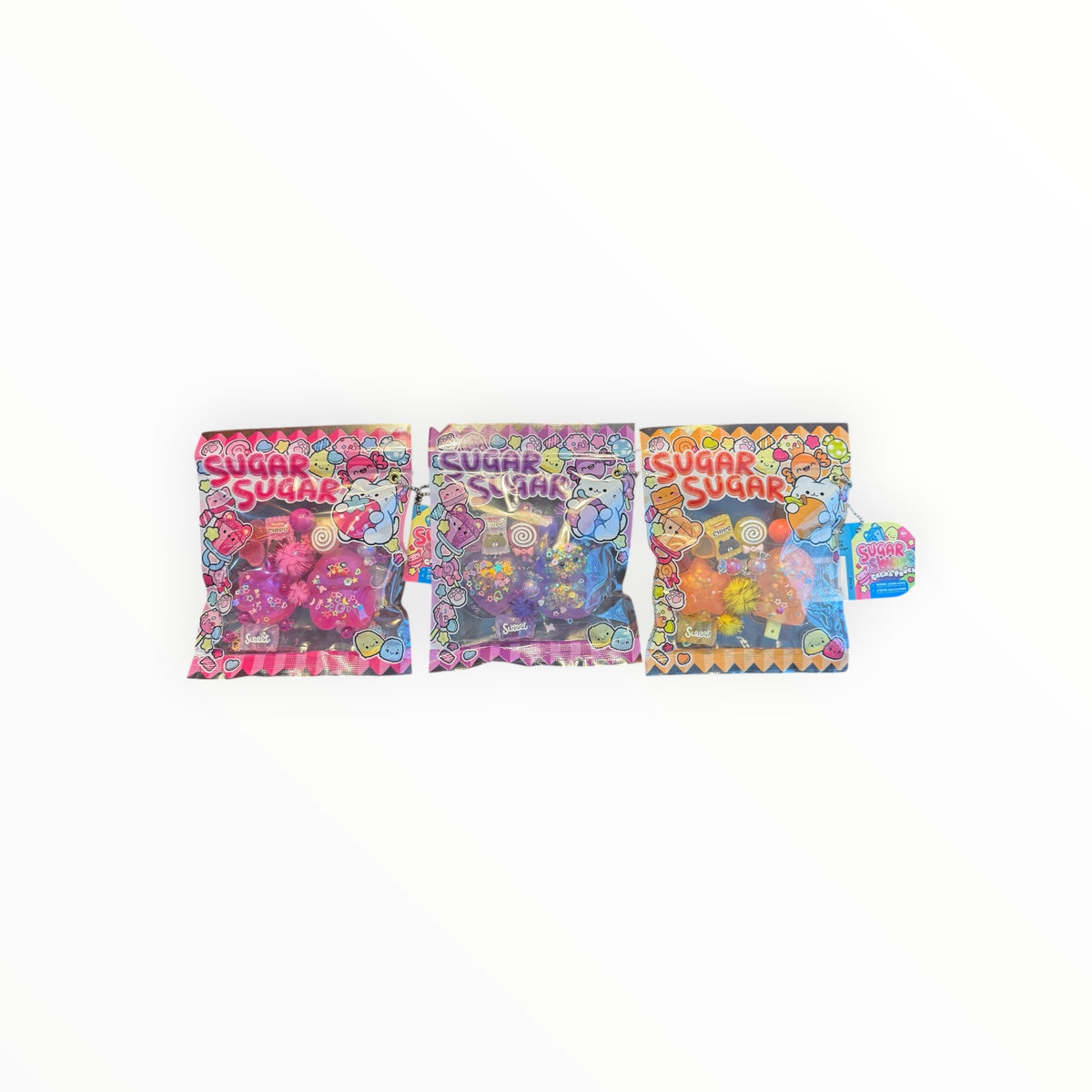 Southern Charm Collectibles Sugar Swap Gacha Pouch set featuring three colorful snack-themed mystery bags with charms
