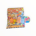 Southern Charm Collectibles Sugar Swap Gacha Pouch with orange snack-themed charms, glitter, and candy accessories.