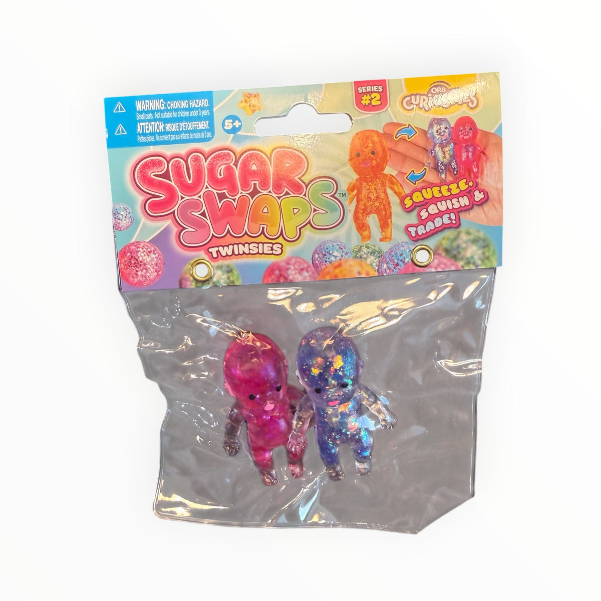 Southern Charm Collectibles Sugar Swaps Twinsies glittery pink and purple squishy baby figures in retail packaging