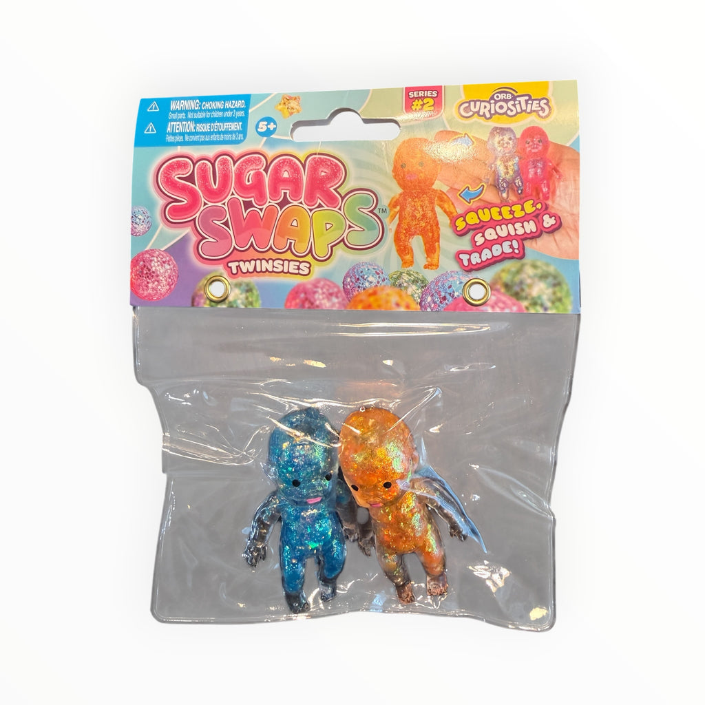 Southern Charm Collectibles Sugar Swaps Twinsies glittery blue and orange squishy baby figures in retail packaging.